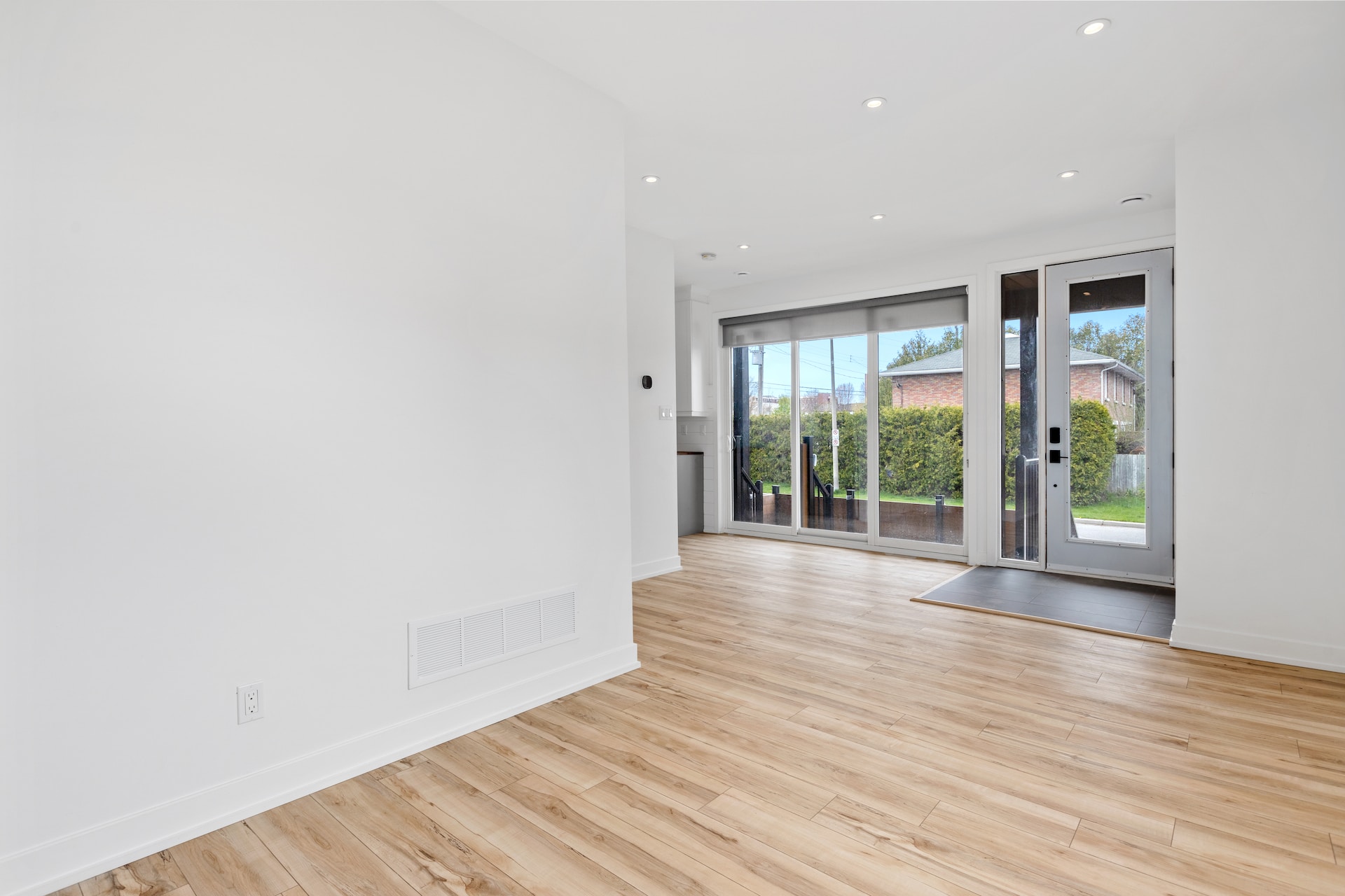 a room with a wood floor and windows